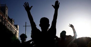 A migrant shouts slogans as others carry a fellow migrant, whom they say was injured during a clash with Spanish police, Ceuta, Spain, Aug. 2, 2026. (Reuters Photo)