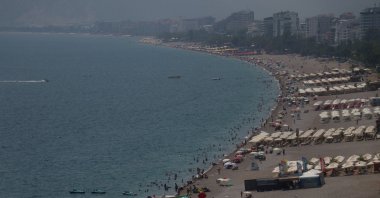 Tourists and residents swim to cool off amid high temperatures and humidity at Konyaaltı Beach, Antalya, Türkiye, Aug. 5, 2026. (AA Photo)