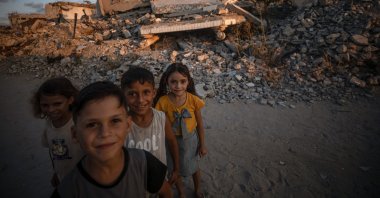Displaced Palestinian children pose for a photograph among the rubble of destroyed buildings, in Jabalya, north of Gaza City, Palestine, Aug. 7, 2026. (EPA Photo)