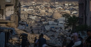 Displaced Palestinians walk amid the rubble of buildings destroyed in Israeli attacks in Jabalya, north of Gaza City, Aug. 7, 2026. (EPA Photo)