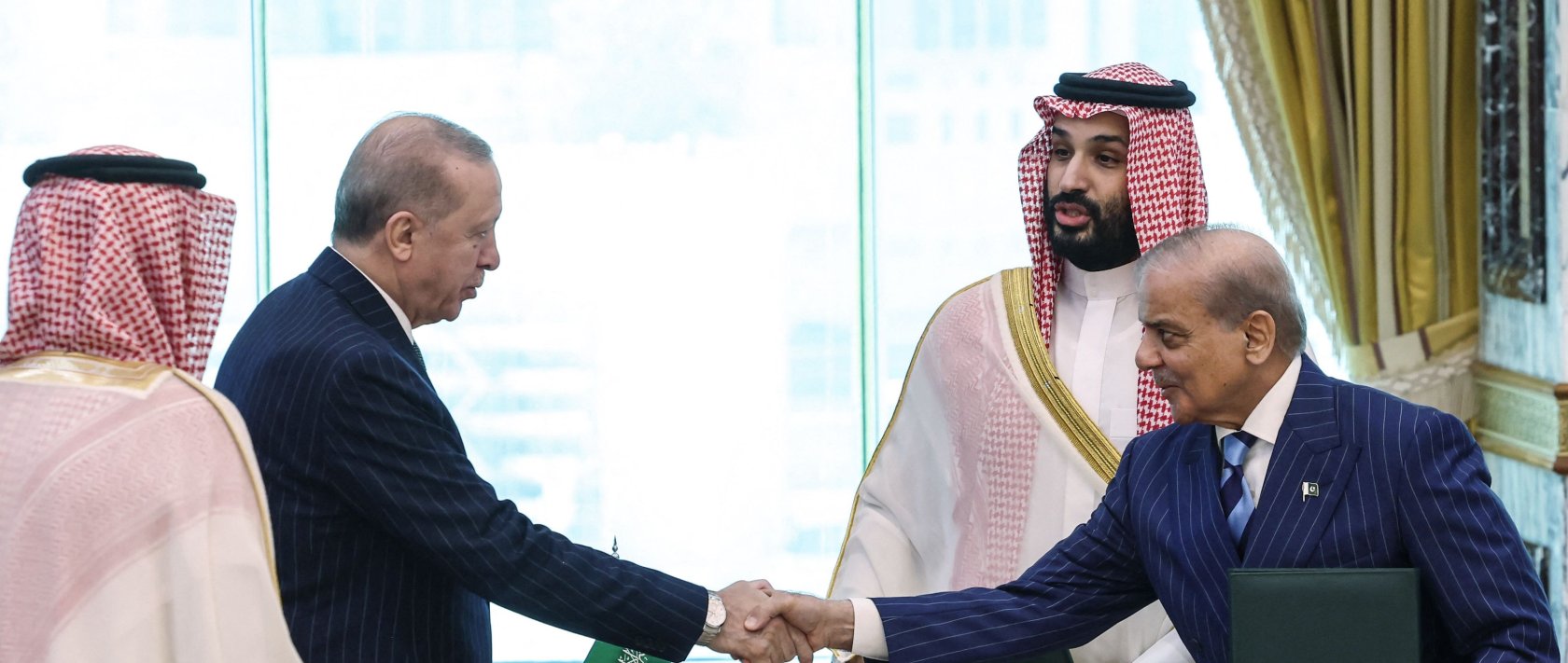 President Recep Tayyip Erdoğan shakes hands with Pakistan’s Prime Minister Shehbaz Sharif (R) as Saudi Arabia's Crown Prince Mohammed bin Salman (2nd-R) looks on after signing a joint defense agreement, Mecca, Saudi Arabia, Aug. 7, 2026. (AFP Photo)