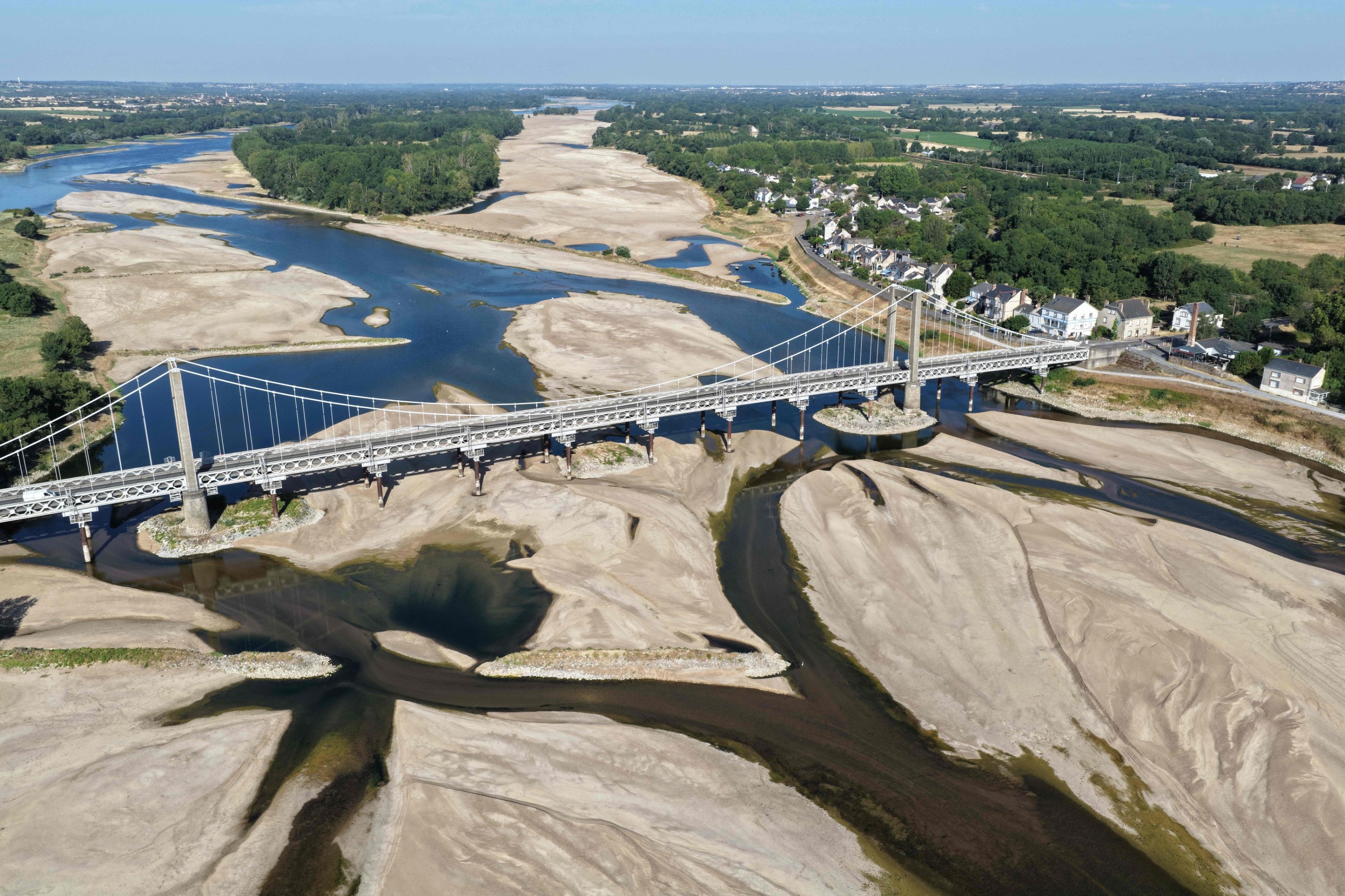 This aerial photograph shows a bridge over the dried-out Loire River bed in Loireauxence, France, July 10, 2026. (AFP Photo)