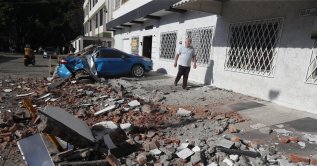 A vehicle damaged by a collapsed wall is seen following an earthquake in Cali, Colombia, Aug. 10, 2026. (EPA Photo)