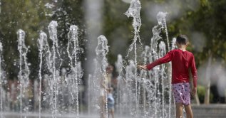 A child cools off in the jets of a fountain in Valencia, Spain, July 15, 2026. (EPA Photo)