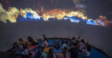 Students explore planets and outer space through immersive visuals during a summer activity, Erzurum, Türkiye, July 21, 2026. (AA Photo)