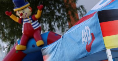 A logo of the Alternative for Germany (AfD) party at a stall during the party's campaign kick-off event ahead of the Mecklenburg-Western Pomerania state election, in Stralsund, Germany, Aug. 8, 2026. (Reuters Photo)