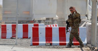 An American soldier waves at the entrance to the LSA Endurance, a logistical support and staging facility designed to support the International Stabilization Force (ISF) under the direction of the Board of Peace (BoP), near the Israel-Gaza border in the Kerem Shalom area, southern Israel, Aug. 10, 2026. (Reuters Photo)