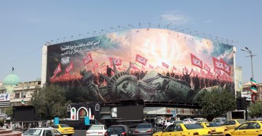 Vehicles drive past an anti-U.S. billboard at Enghelab Square in central Tehran, Iran, Aug. 9, 2026. (EPA Photo)