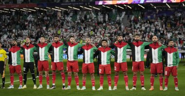 Palestine team players stand for the national anthem ahead of the Asian Cup Group C match between Iran and Palestine at the Education City Stadium, Al Rayyan, Qatar, Jan. 14, 2024. (AP File Photo)