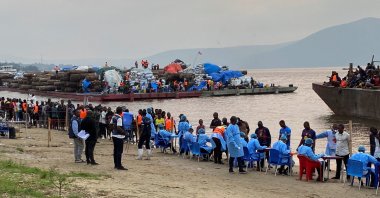 Passengers who disembarked from a boat intercepted by health authorities wait to be tested following the death of a passenger suspected of having Ebola, in Kinshasa, Democratic Republic of the Congo, Aug. 6, 2026. (Reuters Photo)