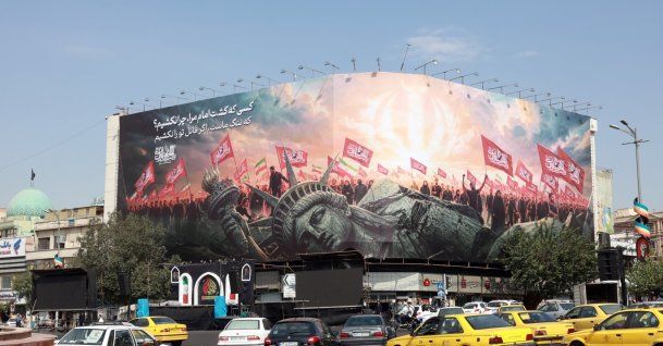 Vehicles drive past an anti-U.S. billboard at Enghelab Square in central Tehran, Iran, Aug. 9, 2026. (EPA Photo)