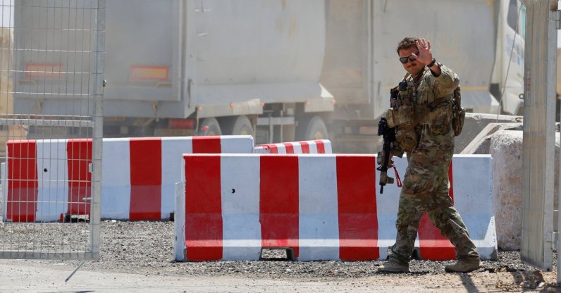 An American soldier waves at the entrance to the LSA Endurance, a logistical support and staging facility designed to support the International Stabilization Force (ISF) under the direction of the Board of Peace (BoP), near the Israel-Gaza border in the Kerem Shalom area, southern Israel, Aug. 10, 2026. (Reuters Photo)