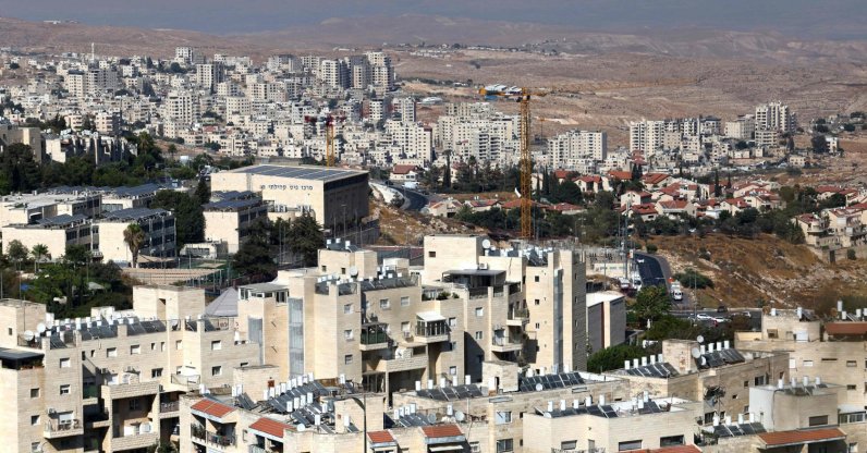 The illegal Israeli settlement of Pisgat Zeev (foreground) in the northern area of east Jerusalem and Israel's unlawful barrier separating the Palestinian town Hzma (background) are pictured in the occupied West Bank, Aug. 7, 2026. (AFP Photo)
