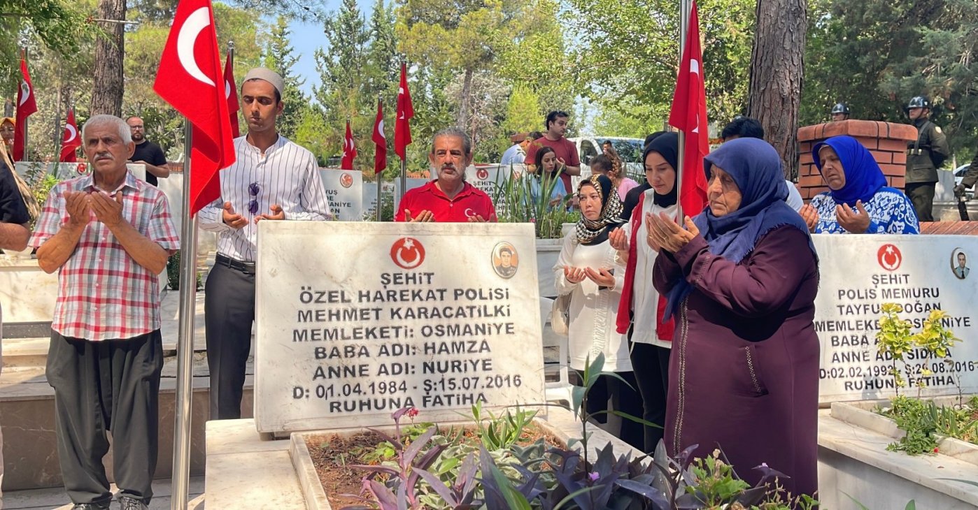 People pray by the grave of a police officer martyred during the 2016 coup attempt by terrorist group FETÖ, in Osmaniye, southern Türkiye, July 15, 2026. (İHA Photo) 
