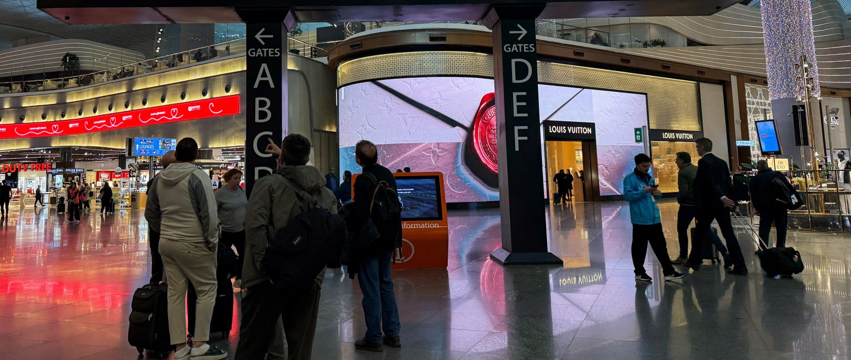 Passengers look at flight information boards after landing at Istanbul Airport in Istanbul, Türkiye, March 12, 2026. (Reuters Photo)