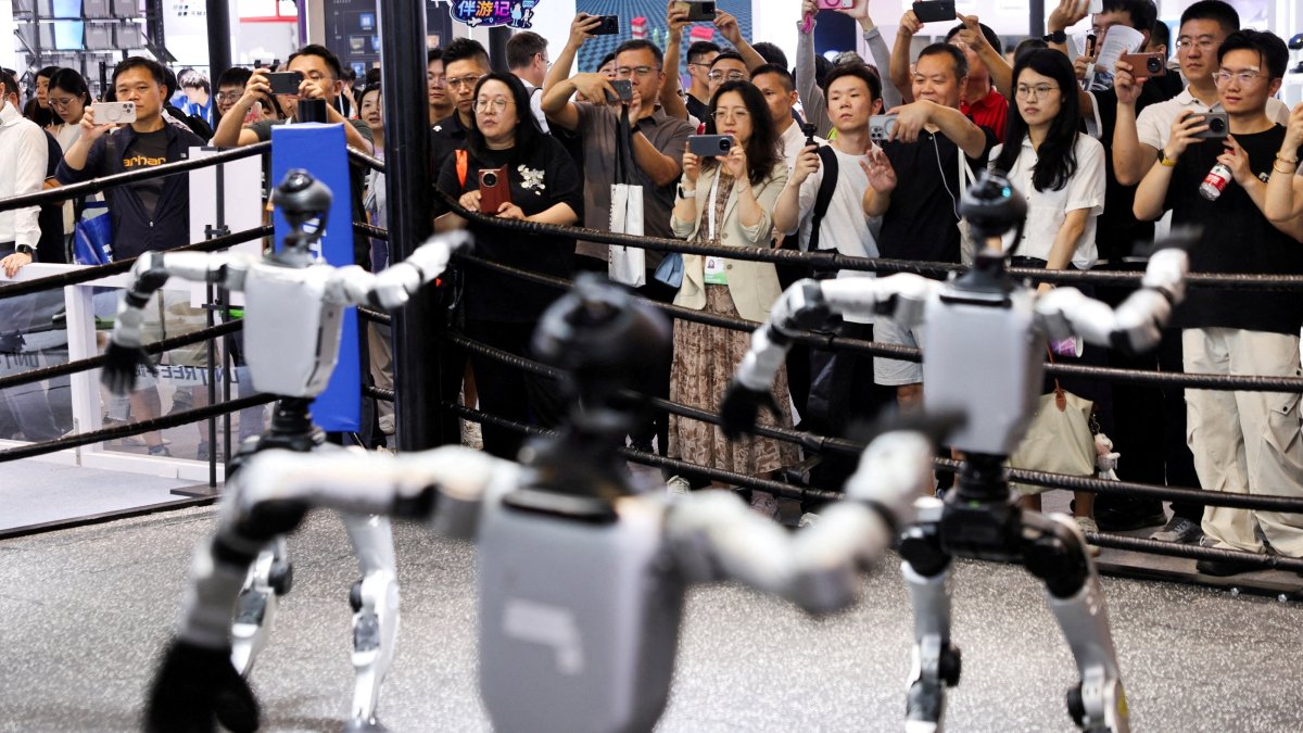 People watch humanoid robots dance at the Unitree booth during the World Artificial Intelligence Conference (WAIC), Shanghai, China, July 17, 2026. (Reuters Photo)