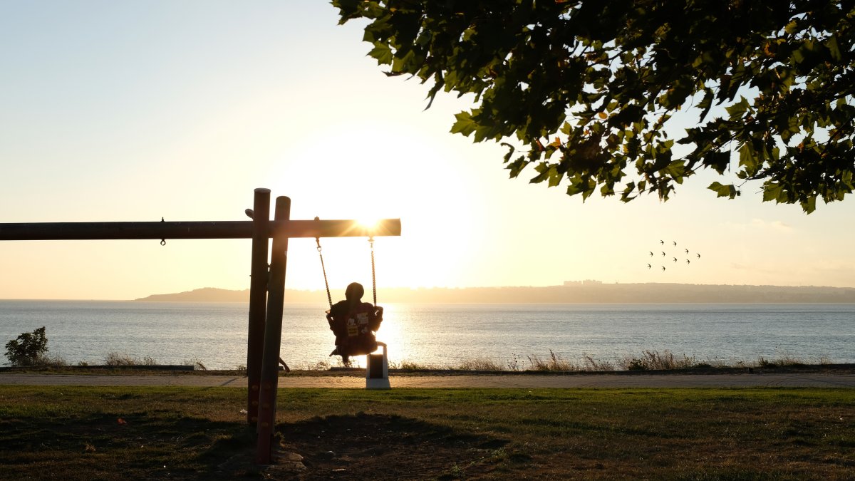 A girl swings on a swing at sunset at a park, Beylikdüzü, Istanbul, Türkiye, July 24, 2020. (Getty Images Photo)