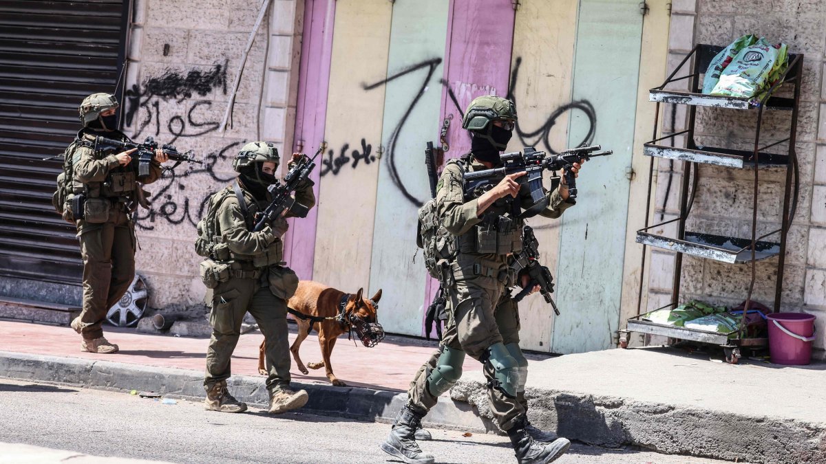Israeli forces patrol along a street during a military raid in the Qalandia refugee camp, south of Ramallah, Israeli-occupied West Bank, Palestine, Aug. 5, 2026. (AFP Photo)