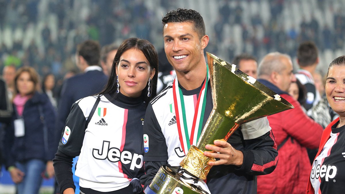 Cristiano Ronaldo #7 of Juventus FC and Georgina Rodriguez celebrate with the trophy after winning the Serie A Championship at the end of the serie A match between Juventus FC and Atalanta BC at Allianz Stadium, May 19, 2019 in Turin, Italy. (AFP File Photo)