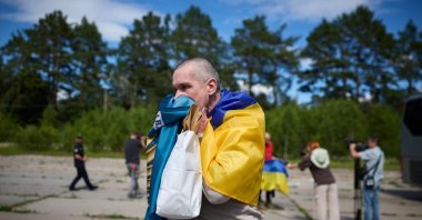 A Ukrainian prisoner of war reacts after a prisoner exchange at an undisclosed location, June 26, 2026. (AP Photo)