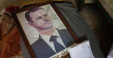 A portrait of Syrian dictator Bashar Assad is pictured with its frame broken at a Political Security Branch facility following the area's capture by anti-government forces, Hama, Syria, Dec. 7, 2024. (AFP Photo)