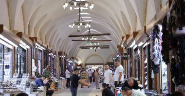 Vendors and passerby are seen in a historic bazaar, Kahramanmaraş, southern Türkiye, July 20, 2026. (IHA Photo)