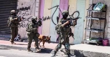Israeli forces patrol along a street during a military raid in the Qalandia refugee camp, south of Ramallah, Israeli-occupied West Bank, Palestine, Aug. 5, 2026. (AFP Photo)