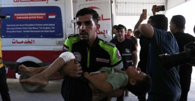 The body of Palestinian child Mousa Al-Habeel, who was killed along with his father in an Israeli airstrike, is brought to Shifa Hospital in Gaza City, Palestine, June 15, 2026. (AP Photo)