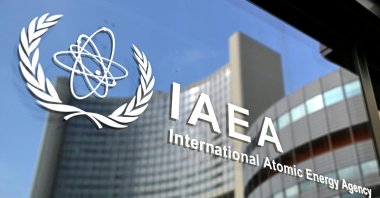 The logo of the International Atomic Energy Agency (IAEA), on the grounds of the Vienna International Centre in Vienna, Austria, March 2, 2026. (AFP File Photo)