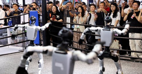 People watch humanoid robots dance at the Unitree booth during the World Artificial Intelligence Conference (WAIC), Shanghai, China, July 17, 2026. (Reuters Photo)