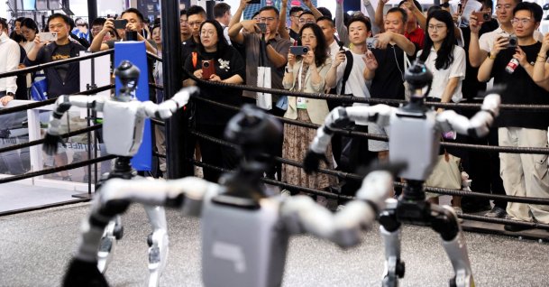 People watch humanoid robots dance at the Unitree booth during the World Artificial Intelligence Conference (WAIC), Shanghai, China, July 17, 2026. (Reuters Photo)