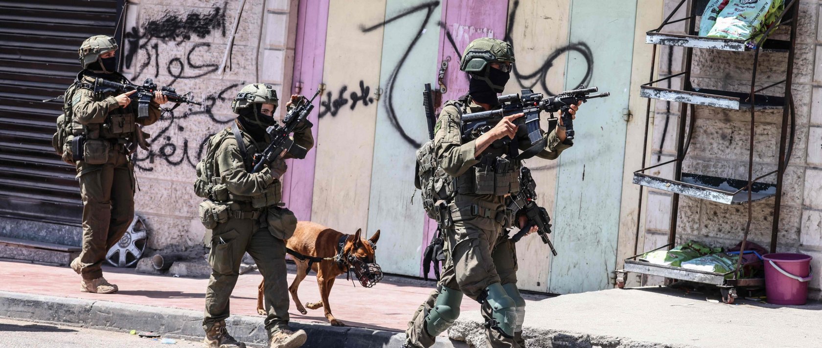 Israeli forces patrol along a street during a military raid in the Qalandia refugee camp, south of Ramallah, Israeli-occupied West Bank, Palestine, Aug. 5, 2026. (AFP Photo)