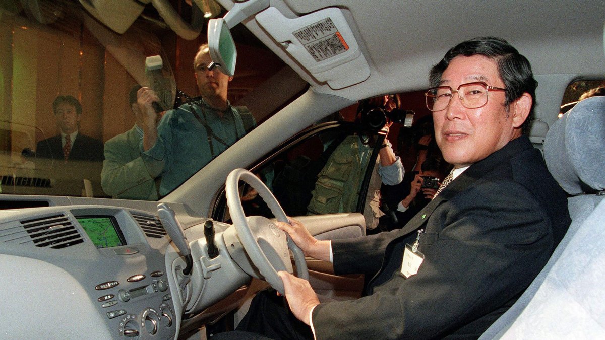 This file photo shows Japan's former Toyota Motor Corp. President Hiroshi Okuda sitting in the driver's seat of then-newly developed "Prius," a passenger vehicle powered by the highly advanced Toyota Hybrid System, Tokyo, Japan, Oct. 14, 1997. (AFP Photo)