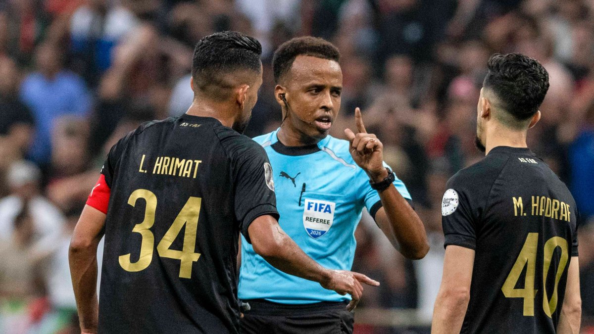 Referee Omar Artan (C) is confronted by players after calling a penalty kick during the CAF Champions League final match between AS FAR Rabat and Mamelodi Sundowns, Rabat, Morocco, May 24, 2026. (AP Photo)