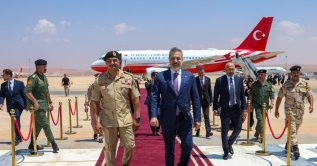 Saddam Haftar (L) and Foreign Minister Hakan Fidan walk on the red carpet at the welcoming ceremony for Fidan, Benghazi, Libya, Aug. 12, 2026. (AA Photo)