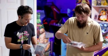 In this photo provided by Nintendo Wire, publisher Jason Ganos (L) and OneStopWonders store owner Kevin Braun hold PSA graded copies of Super Mario Bros. and Duck Hunt video games, Wisconsin, U.S.,June 17, 2026. (AP Photo)
