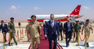 Saddam Haftar (L) and Foreign Minister Hakan Fidan walk on the red carpet at the welcoming ceremony for Fidan, Benghazi, Libya, Aug. 12, 2026. (AA Photo)