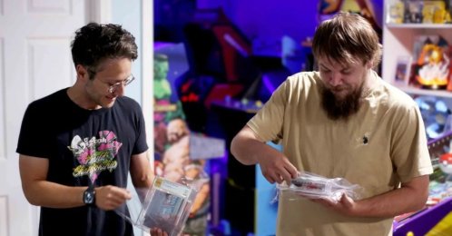 In this photo provided by Nintendo Wire, publisher Jason Ganos (L) and OneStopWonders store owner Kevin Braun hold PSA graded copies of Super Mario Bros. and Duck Hunt video games, Wisconsin, U.S.,June 17, 2026. (AP Photo)