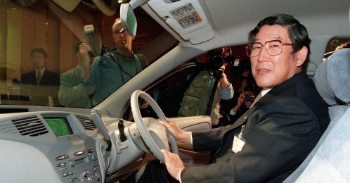 This file photo shows Japan's former Toyota Motor Corp. President Hiroshi Okuda sitting in the driver's seat of then-newly developed "Prius," a passenger vehicle powered by the highly advanced Toyota Hybrid System, Tokyo, Japan, Oct. 14, 1997. (AFP Photo)