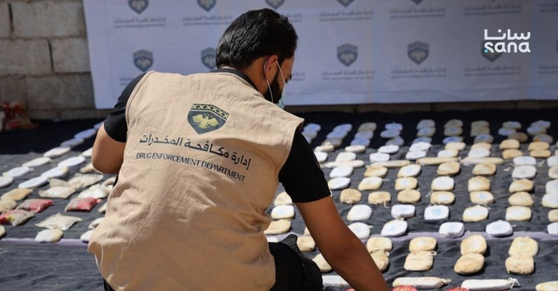 A member of Syria's Drug Enforcement Department inspects seized narcotics during an operation in Syria, in this photo released on Aug. 12, 2026. (SANA Photo)