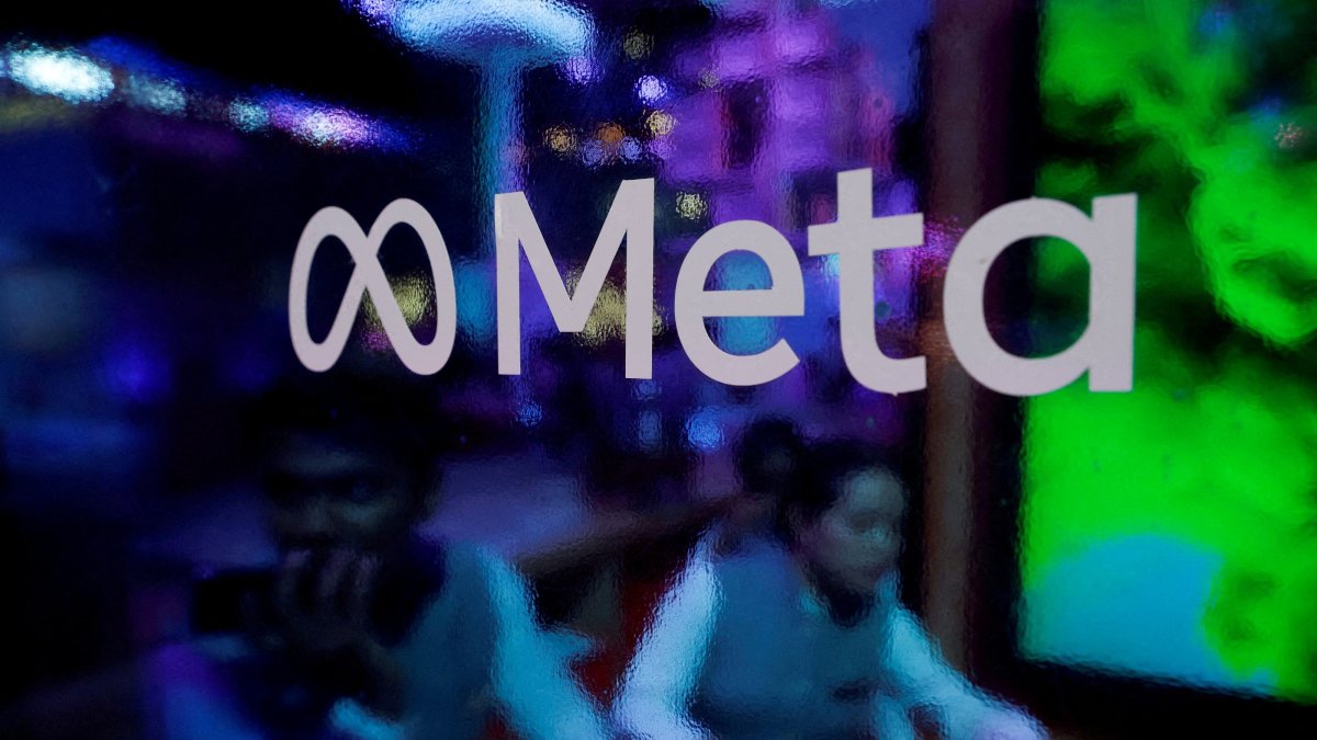 People are seen behind a logo of Meta Platforms during a conference, Mumbai, India, Sept. 20, 2023. (Reuters Photo)