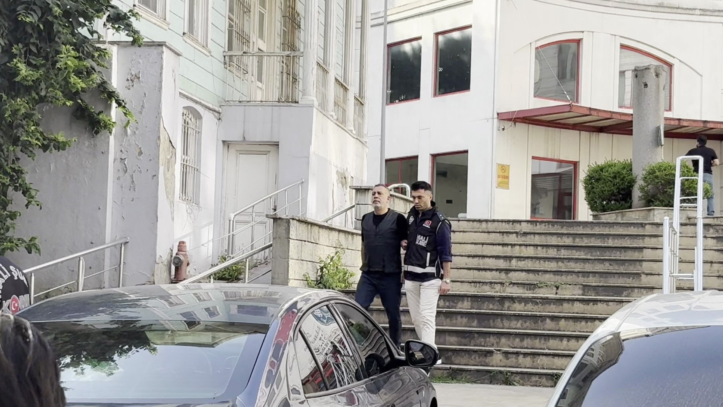 Haluk Levent is escorted for a health check after being detained in an Ahbap Association corruption probe, Istanbul, Türkiye, July 15, 2026. (IHA Photo)