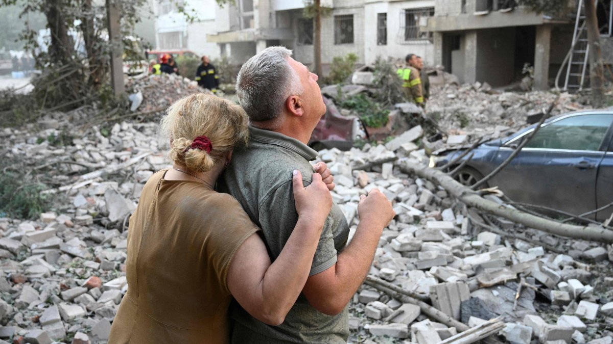Locals react outside a residential building partially destroyed as a result of Russian missile strikes in Lviv, western Ukraine, July 30, 2026. (AFP Photo)