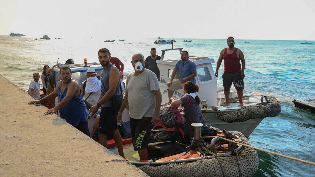 Locals and tourists are evacuated by boat from the seaside town of Siviri, following a wildfire fanned by strong winds, on the Halkidiki peninsula, Greece, Aug. 13, 2026. (Reuters Photo)