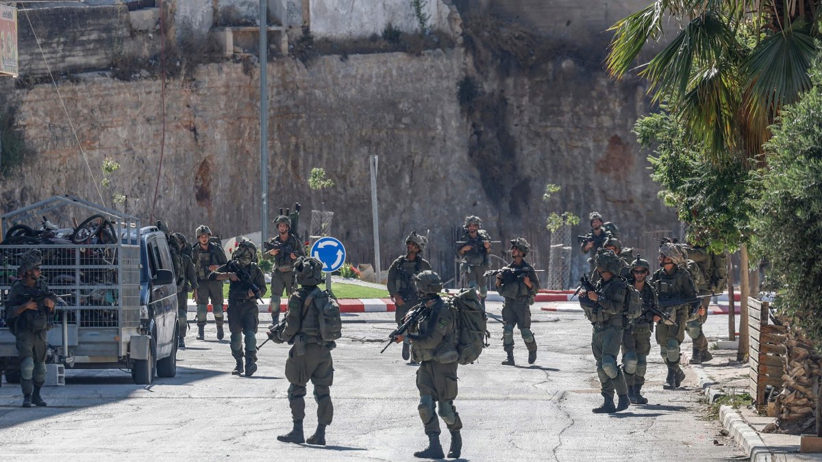 Israeli soldiers patrol a street as they are deployed during an operation in the village of Qusra, south of Nablus, in the Israeli-occupied West Bank, Aug.13, 2026. (AFP Photo)