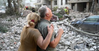 Locals react outside a residential building partially destroyed as a result of Russian missile strikes in Lviv, western Ukraine, July 30, 2026. (AFP Photo)