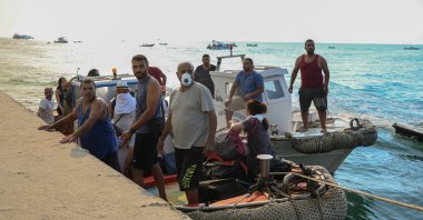 Locals and tourists are evacuated by boat from the seaside town of Siviri, following a wildfire fanned by strong winds, on the Halkidiki peninsula, Greece, Aug. 13, 2026. (Reuters Photo)
