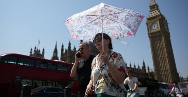 A woman walks with an umbrella during a heatwave in London, Britain, Aug. 13, 2026. (Reuters Photo)