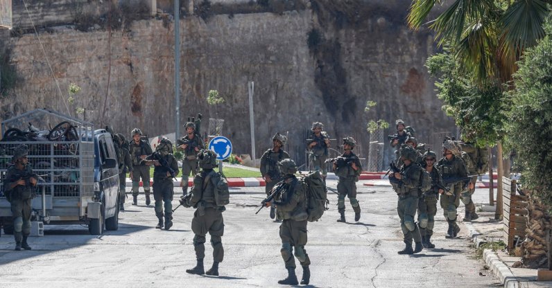Israeli soldiers patrol a street as they are deployed during an operation in the village of Qusra, south of Nablus, in the Israeli-occupied West Bank, Aug.13, 2026. (AFP Photo)