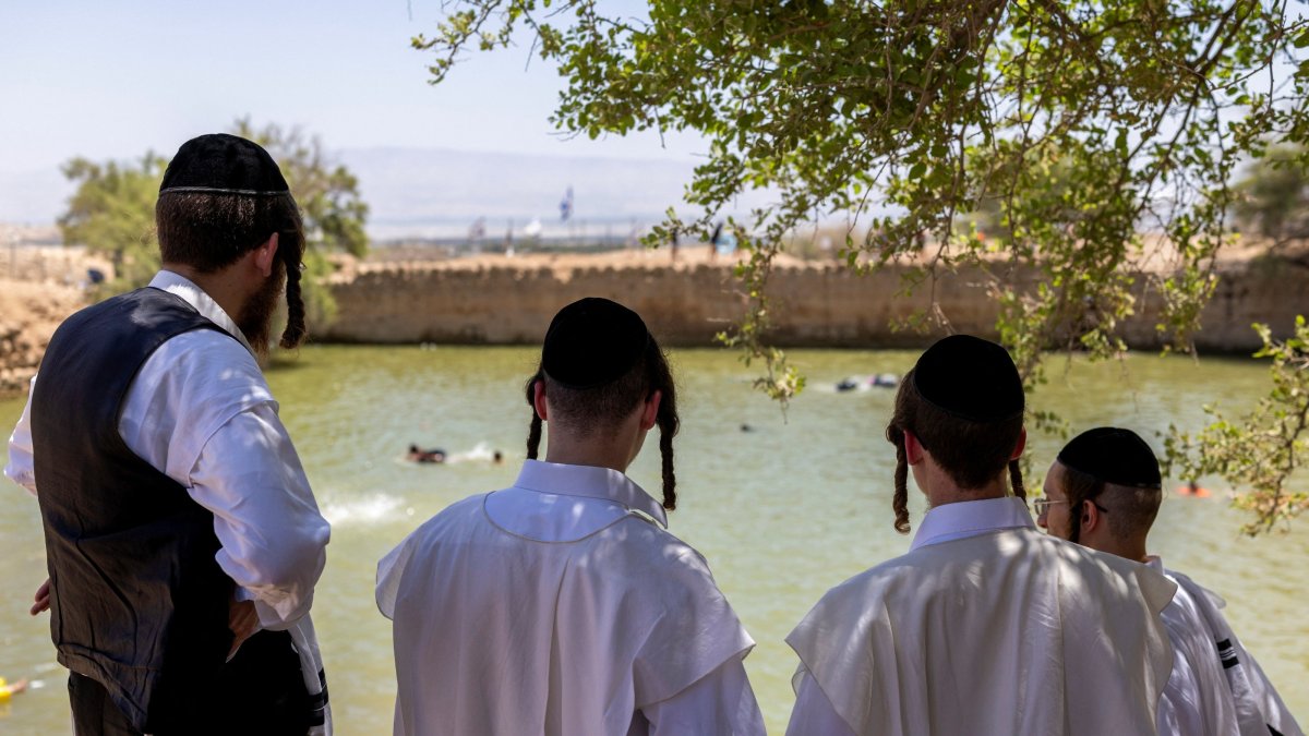 Ultra-Orthodox Jewish people look down at an ancient water reservoir in the Jordan Valley, West Bank, Palestine, Aug. 5, 2026. (Reuters Photo)
